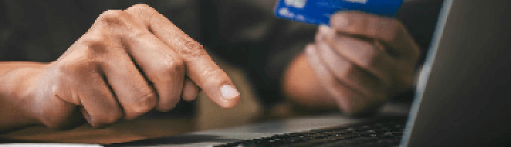 Quelqu'un sur son ordinateur qui paie avec son téléphone